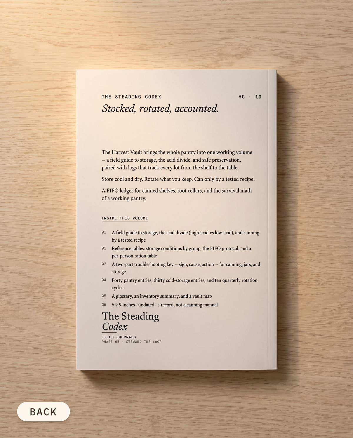 The Harvest Vault pantry and food storage journal — back cover on an oak table