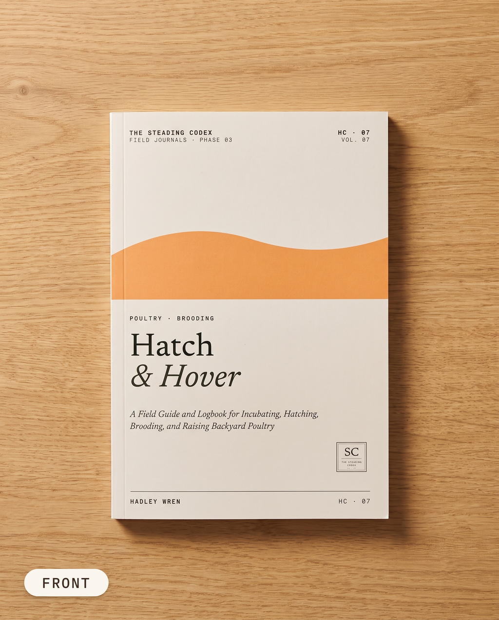 Hatch & Hover poultry hatching journal — front cover on an oak table
