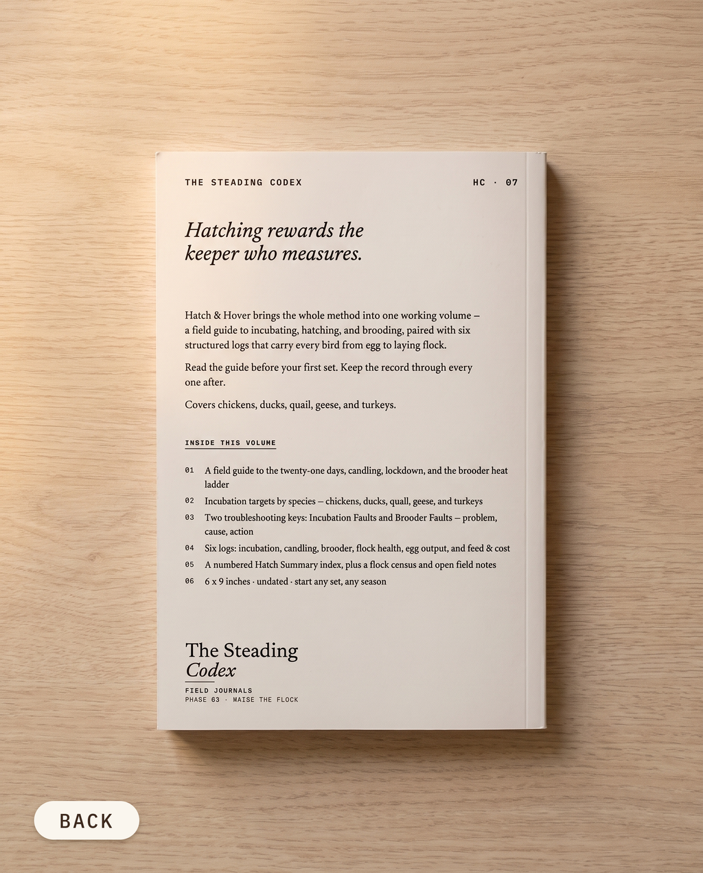 Hatch & Hover poultry hatching journal — back cover on an oak table