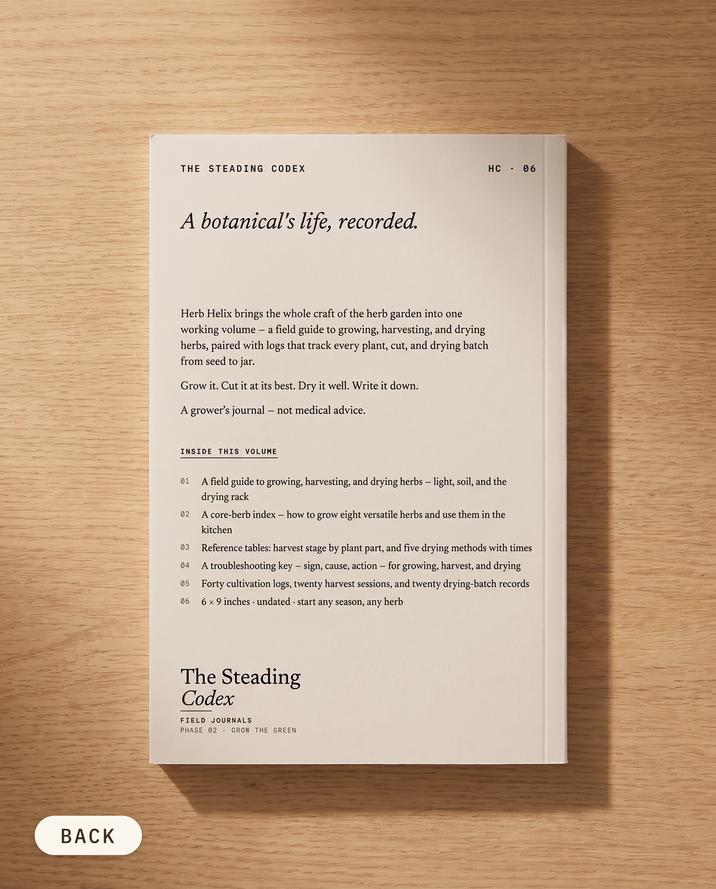 Herb Helix herb growing journal — back cover on an oak table