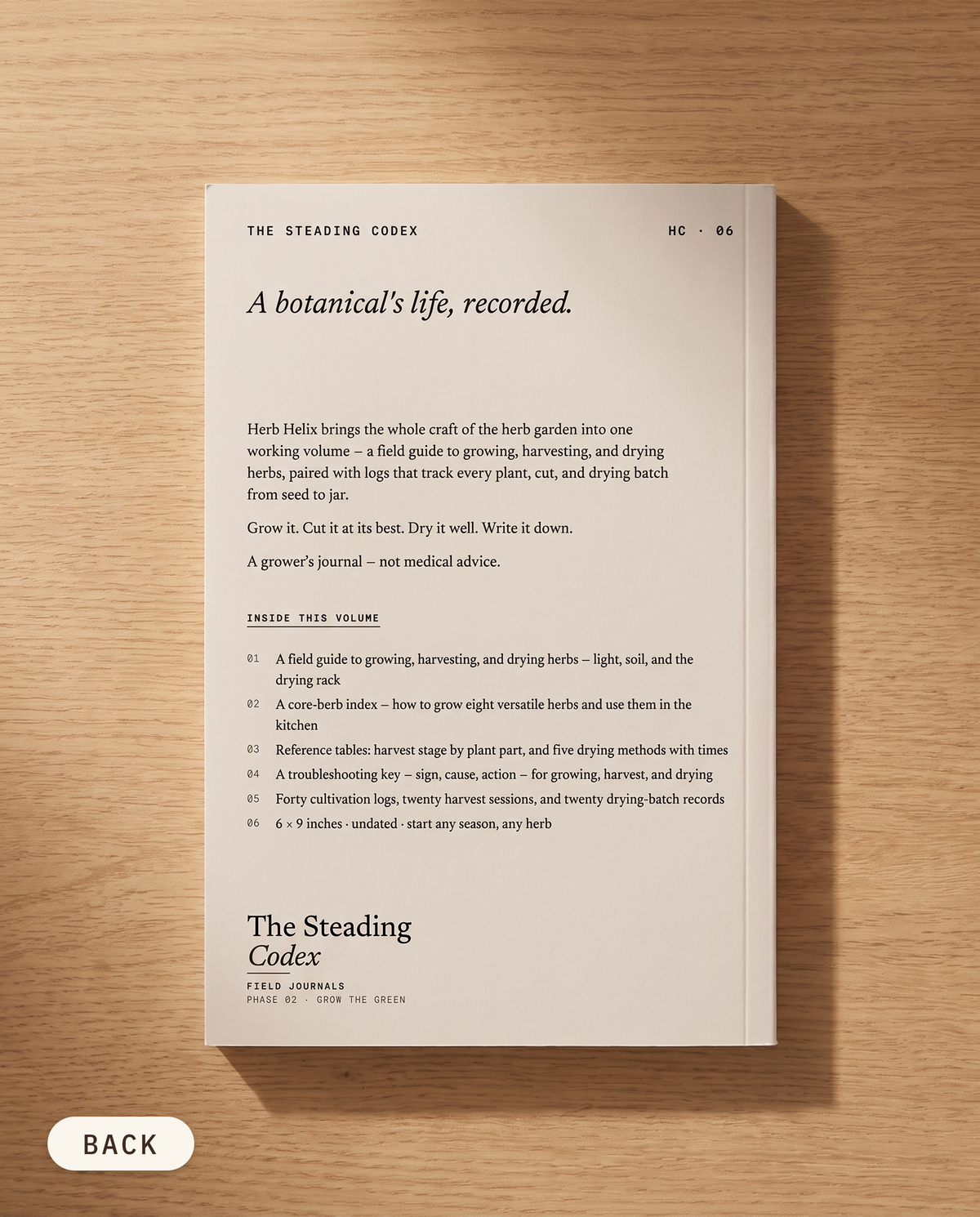 Herb Helix herb growing journal — back cover on an oak table