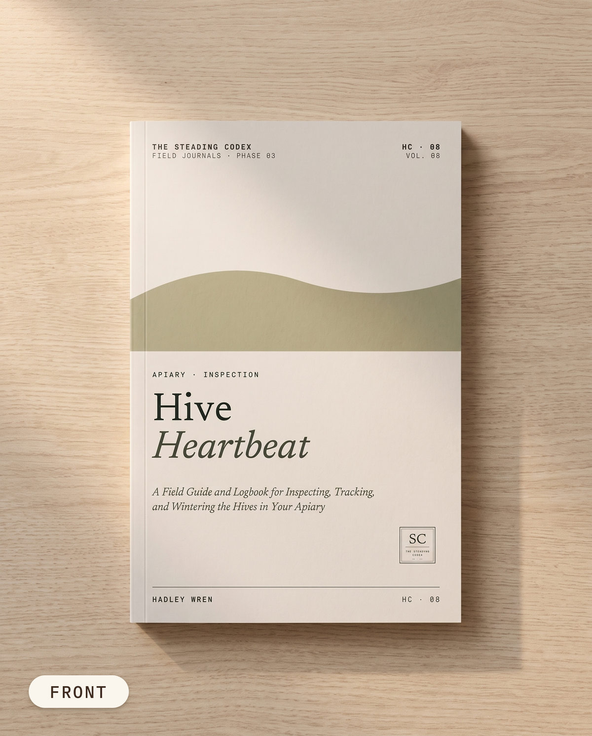 Hive Heartbeat beekeeping journal — front cover on an oak table