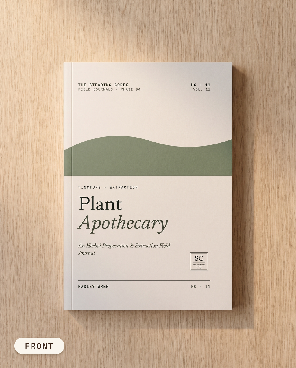 Plant Apothecary herbal preparation journal — front cover on an oak table