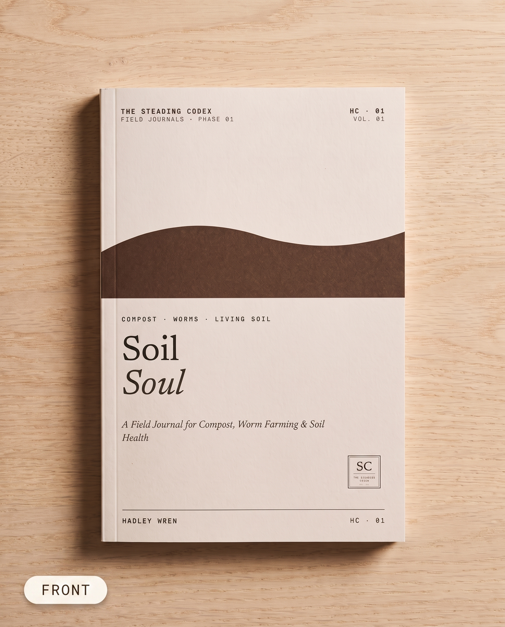 Soil Soul compost journal — front cover on an oak table