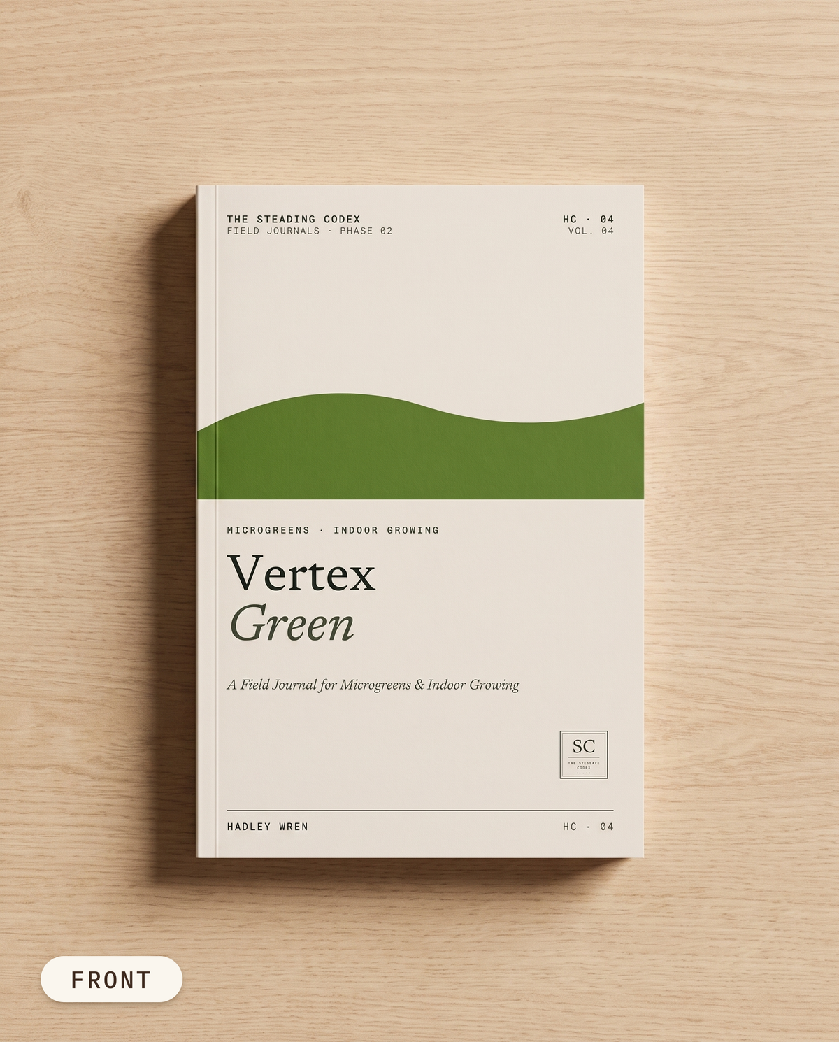Vertex Green microgreens journal — front cover on an oak table